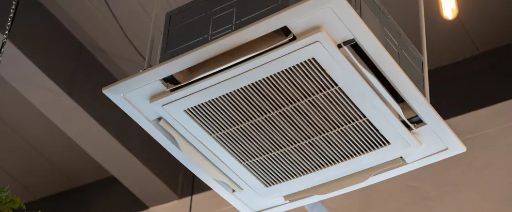 Ceiling-mounted cassette air conditioning unit installed in a commercial or office space.